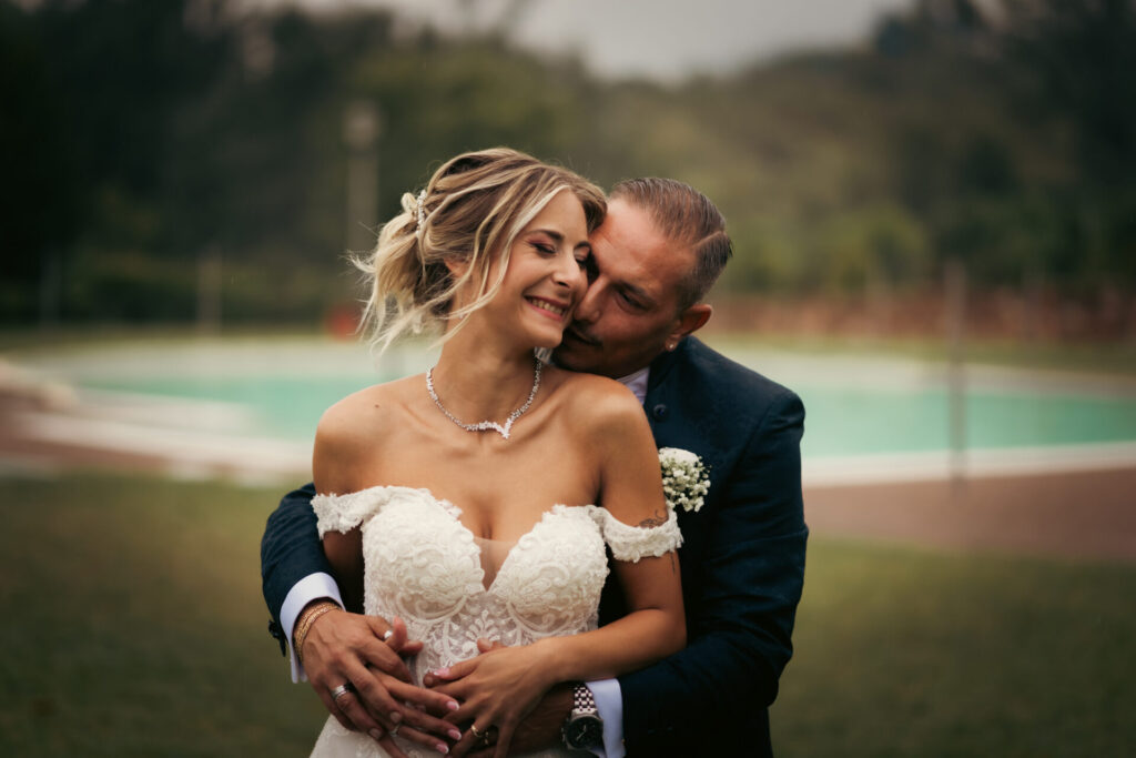 Coppia di sposi a mezzo busto che si abbracciano e sorridono durante il loro matrimonio a Collegno - Torino